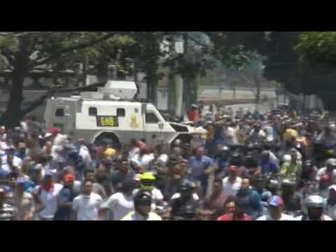 Military vehicle rushes through opposition crowd