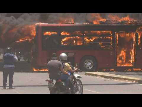 Venezuelan govt bus burns as protesters try to block road access