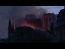 Firefighters battle Notre-Dame fire as night falls