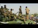 Sudanese soldiers stand amongst protesters near army HQ