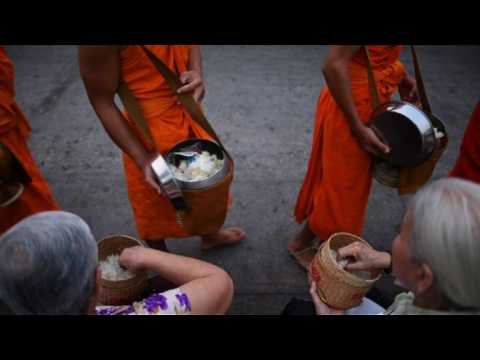 Alms-giving ceremony for Buddhist monks in Luang Prabang