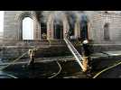 Honduran firefighters try to put out smoking buildings after clashes - Label : AFPTV - First images - Category : News