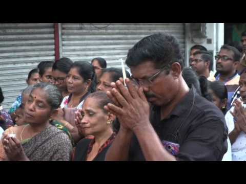 People hold a vigil outside St. Anthony's Shrine