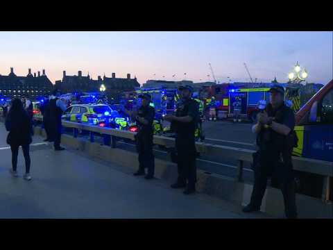 Police officers and firefighters clap in appreciation for healthcare workers on London's Thames