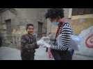 A clown teaches children how to wear masks and gloves in Cairo