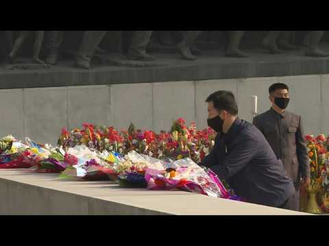 Masked N. Koreans mark late founder Kim Il Sung's birthday