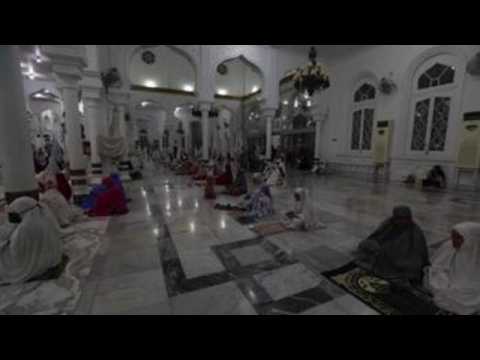 Indonesians pray the night before the start of Ramadan