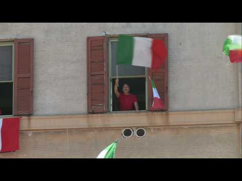 Romans fly flags and sing 'Bella Ciao' from windows to mark Liberation Day