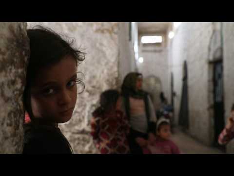 Displaced families seek shelter at abandoned prison in Idlib, Syria