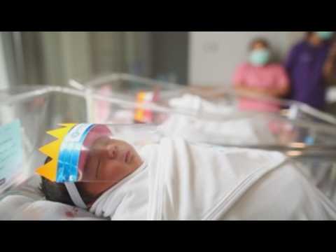 Babies from Thailand wear mini-face shields to fend off COVID-19