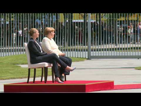 Merkel sits through anthems after shaking spells