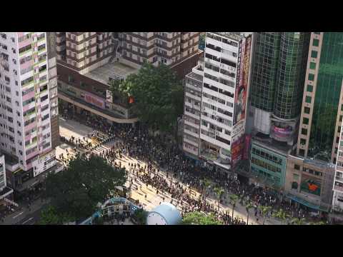 Hong Kong protesters march past police-sanctioned end point