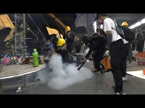 Hong Kong protesters fight back police tear gas