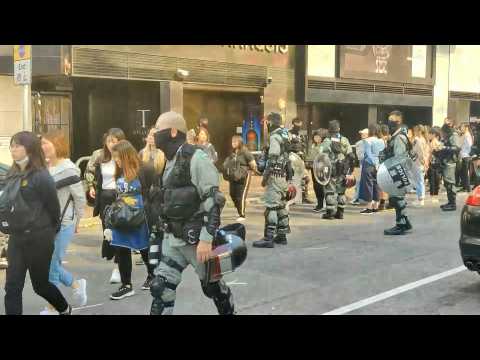 Hong Kong riot police detain people near campus protest siege