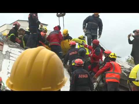 Albania: Rescue teams remove a body from the debris in Durres