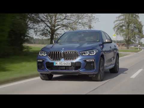 The new BMW X6 M50i Driving in the country