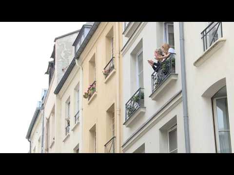Parisians applaud healthcare workers from their windows