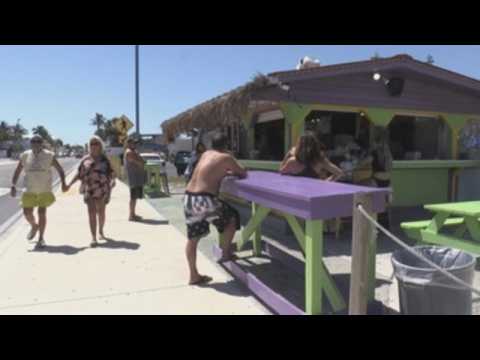 Beaches, businesses reopen in Florida with social distancing rules