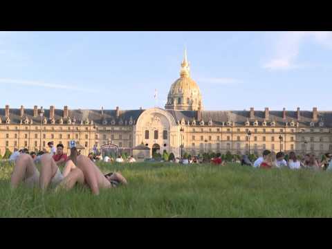 Parisians enjoy the sun in front of the Invalides