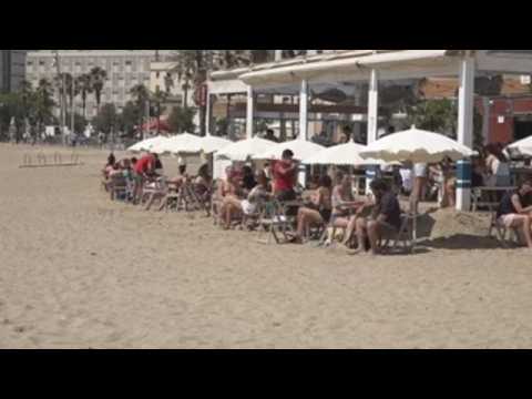 Barcelona residents flock to beaches to enjoy sunny weather