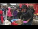 Volunteers distribute food among needy children in Cape Town