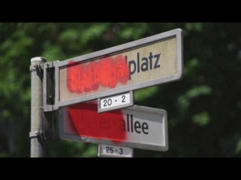 Anti-racism protesters cross out the names of some streets in Berlin