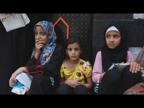 Dozens of people line up for food in Yemen
