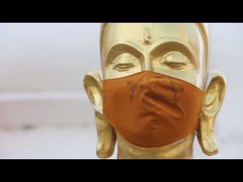 Face masks on Buddha statues at Thai temple to promote use amid pandemic