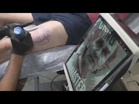Spanish man has coronavirus expert's face tattoed on his leg