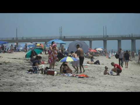 California locals sunbathe and enjoy the water at Huntington Beach on Memorial Day