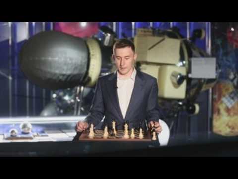 Karjakin plays a game of chess against cosmonaut Ivanishin