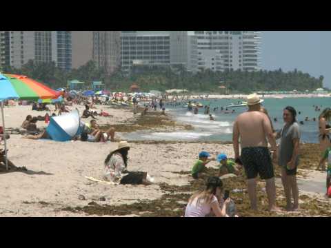 People enjoy a sunny day at the beach as Miami Beach reopens