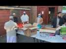 Volunteers distribute food among the Muslim community in London