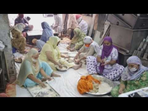 Volunteers in northwestern India distribute food for those in need