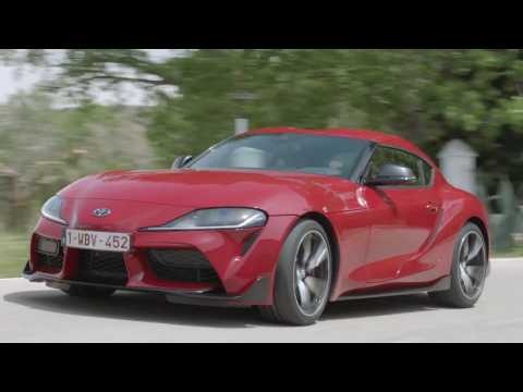 Toyota GR Supra in Red Driving on the road