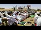 Sudanese protesters take part in the Friday prayers near army HQ