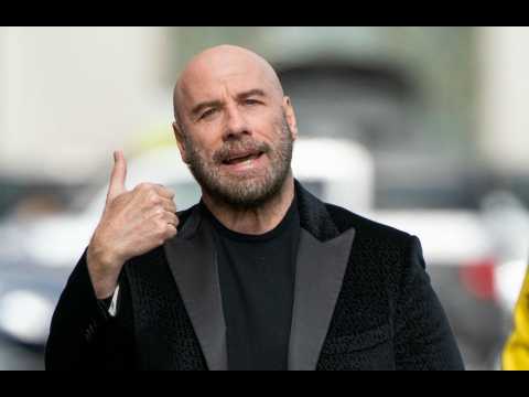 Bald John Travolta encouraged by Pitbull