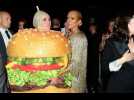 Katy Perry falls over dressed as hamburger