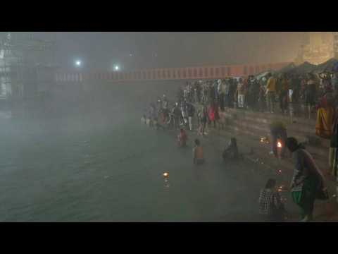 Hindus gather at the river Ganges before sunrise for Kumbh Mela