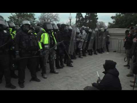 Police in riot gear stand guard outside Capitol