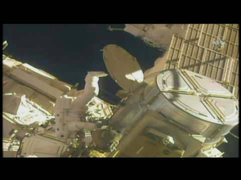 Astronauts carry out external maintenance work on International Space Station