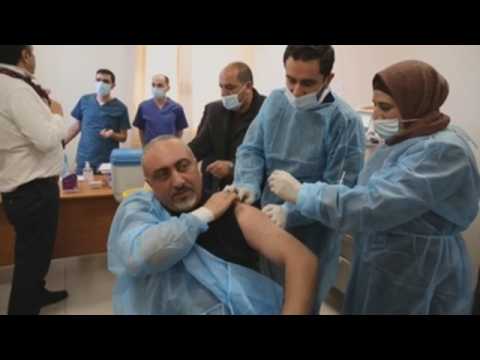 Health workers get coronavirus vaccine in Dura, West Bank