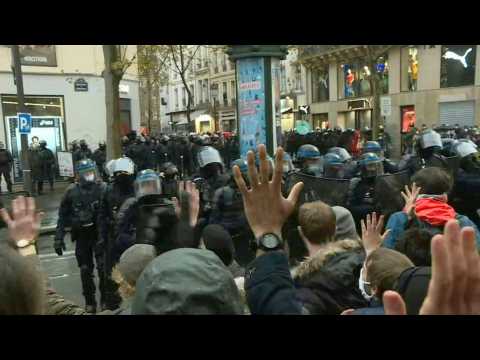 Riot police charge to try to push back Paris security law protesters