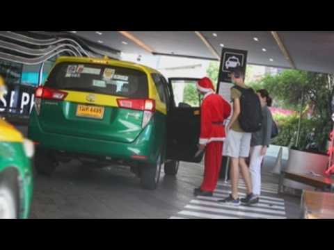 Bangkok mall staff welcome Christmas dressed as Santa Claus