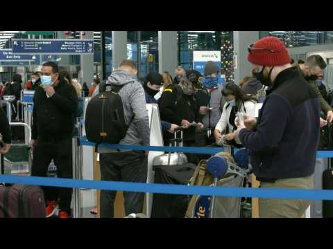 People queue inside Chicago airport to travel for holidays amid pandemic