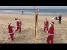 'Santa Clauses' play voleyball on Tel Aviv beach