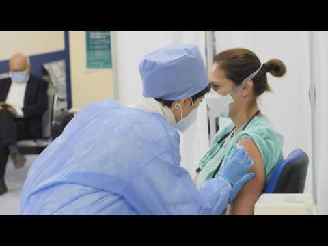 Italy: health workers receive first vaccinations in hard-hit Lombardy region