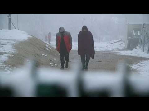 Snow falls as migrants continue to wait for shelter in Bosnia