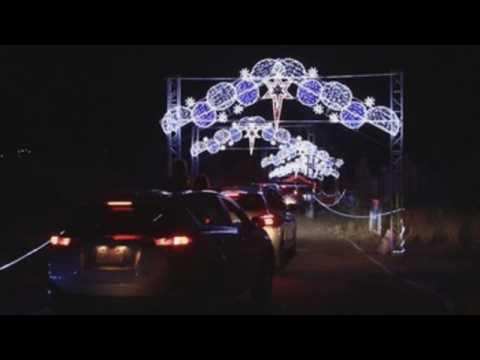 Mexican children enjoy Christmas lights from their cars to prevent contagion