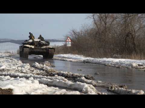 Ukrainian tanks and infantry vehicles head through snow to the frontline